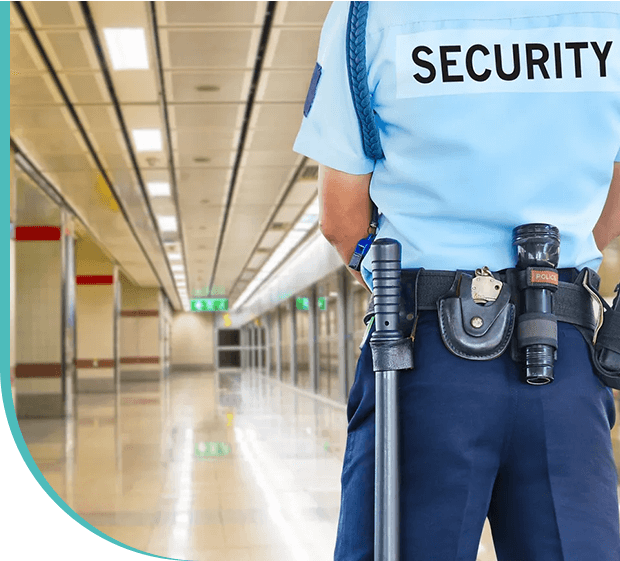 A security guard standing in an empty building.