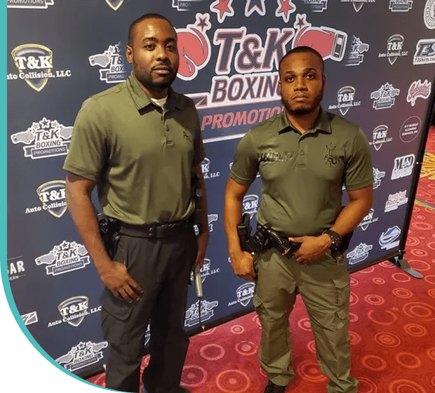 Two men standing in front of a red carpet.