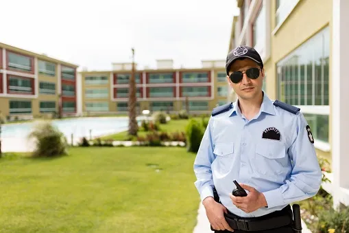 A man in uniform holding a remote control.